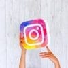 Instagram logo with hands and white background